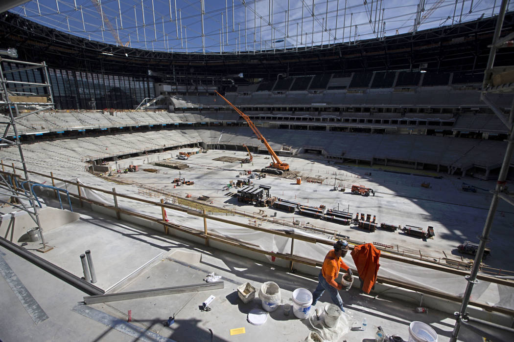 Construction crews on the field level of the the Raiders Allegiant Stadium in Las Vegas, Tuesda ...