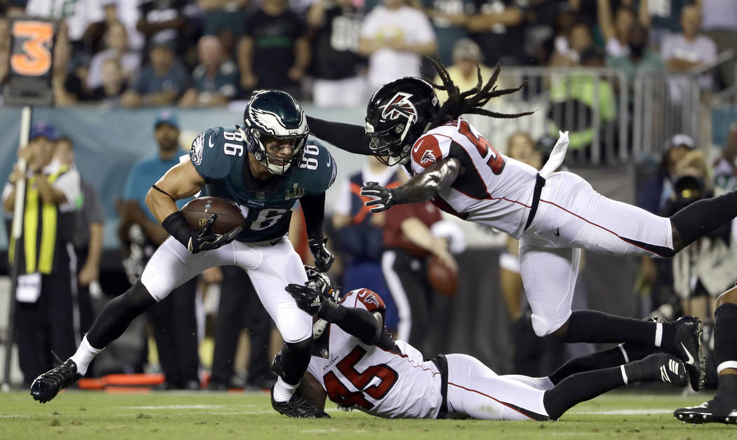 Philadelphia Eagles' Zach Ertz (86) tries to escape from Atlanta Falcons' Deion Jones (45) and ...