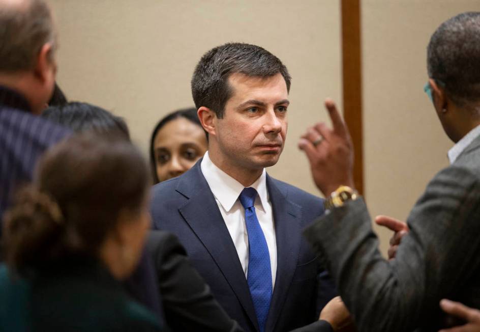 Democratic presidential candidate former South Bend Mayor Pete Buttigieg, middle, speaks with s ...