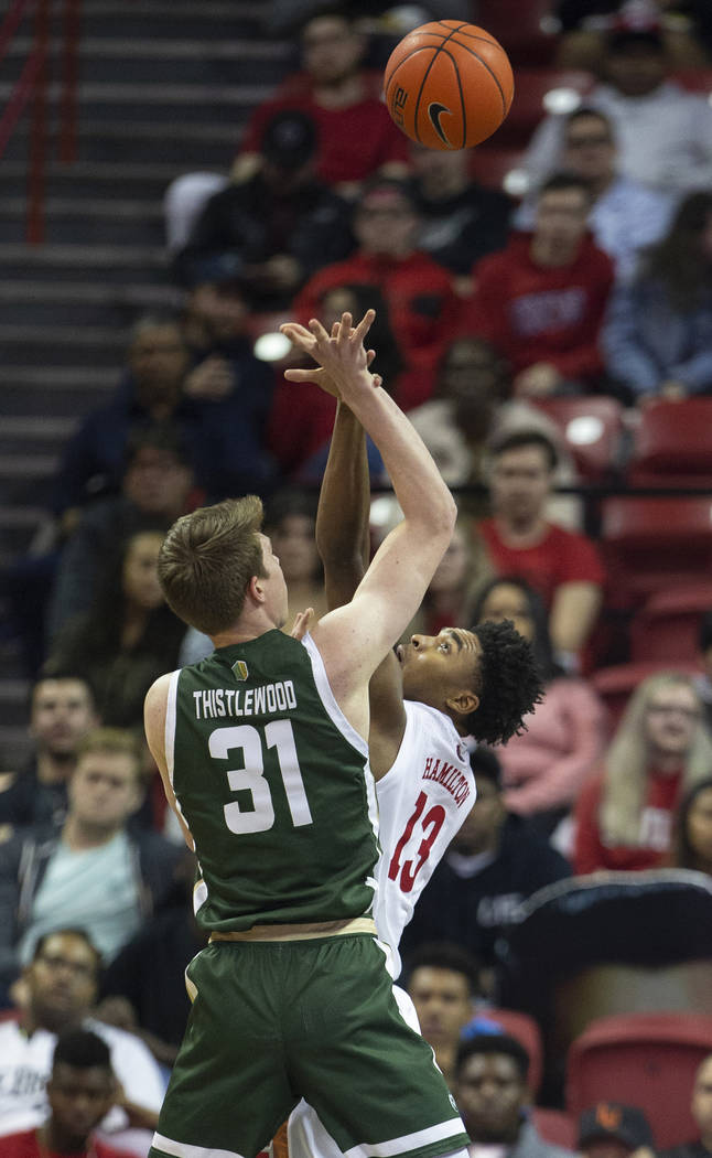 UNLV Rebels guard Bryce Hamilton (13) contests the shot of Colorado State Rams forward Adam Thi ...