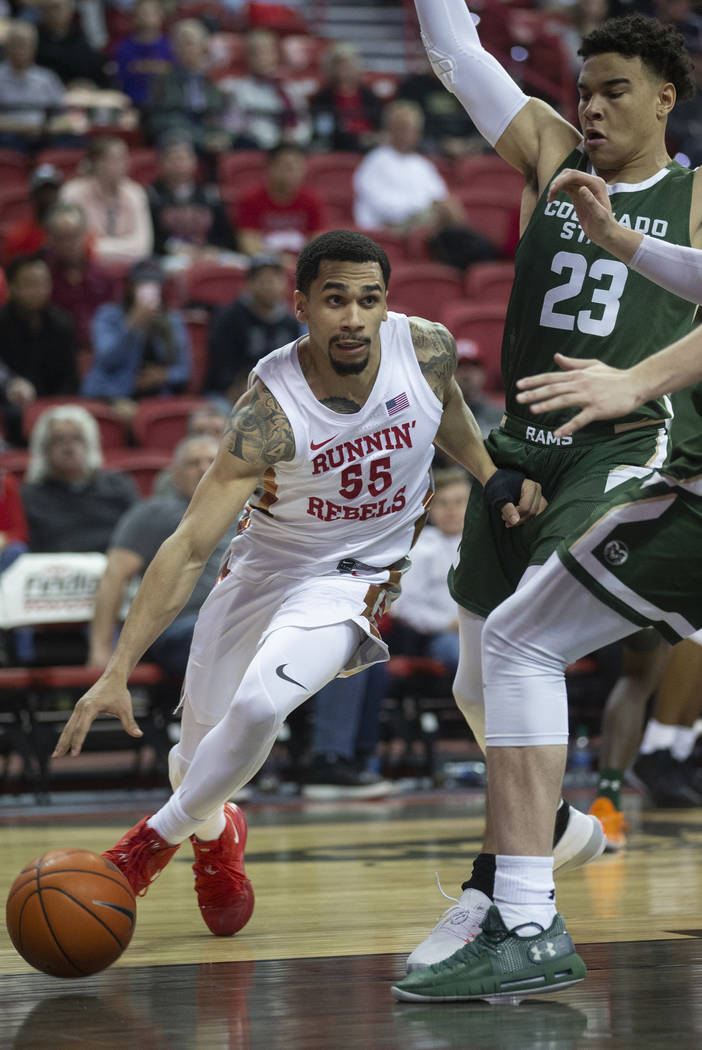 UNLV Rebels guard Elijah Mitrou-Long (55) drives baseline past Colorado State Rams guard John T ...