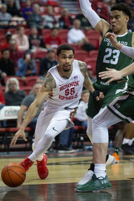 UNLV Rebels guard Elijah Mitrou-Long (55) drives baseline past Colorado State Rams guard John T ...