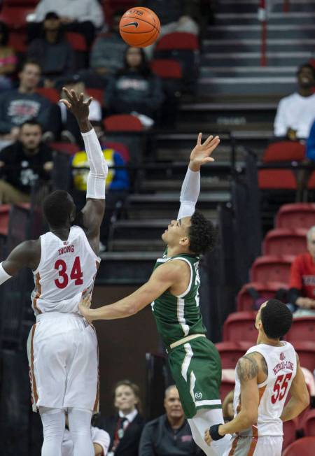 UNLV Rebels forward Cheikh Mbacke Diong (34) reaches to block the shot of Colorado State Rams g ...