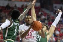 UNLV Rebels forward Nick Blair (20) drives past Colorado State Rams guard Kris Martin (1) and C ...