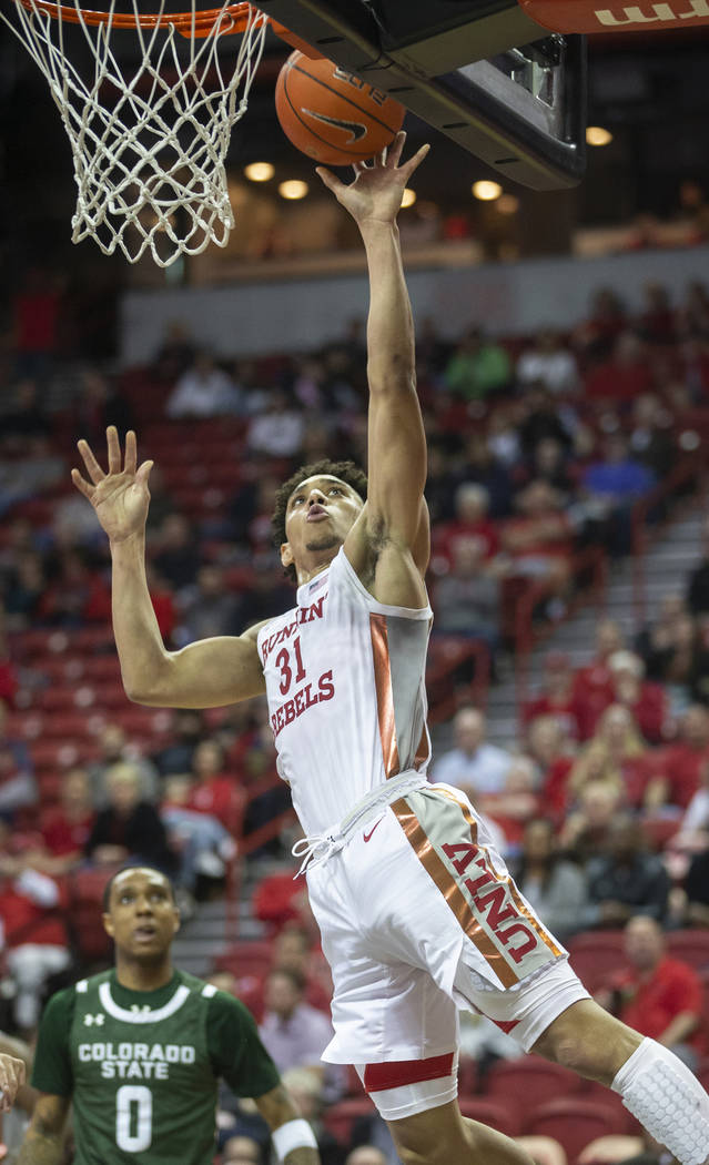 UNLV Rebels guard Marvin Coleman (31) drives over Colorado State Rams guard Hyron Edwards (0) i ...