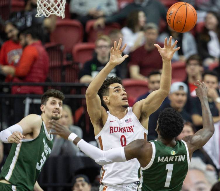 UNLV Rebels guard Jay Green (0) fights for a rebound with Colorado State Rams guard Kris Martin ...