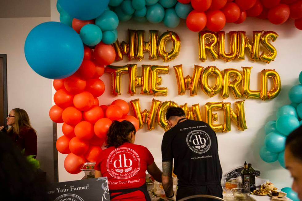 Claudia Andracki, owner of Desert Bloom Eco Farm, left, prepares food during a culinary celebra ...