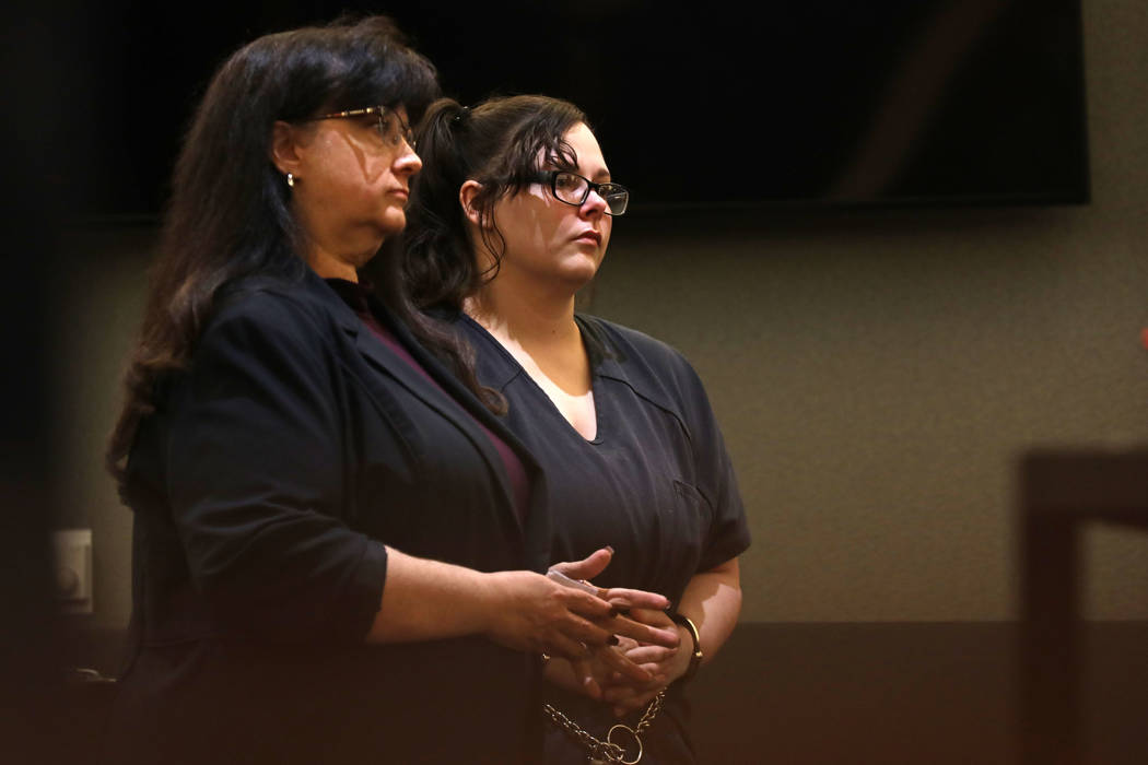 Cassie Smith, right, charged in the death of her 3-year-old son, Daniel Theriot, listens during ...