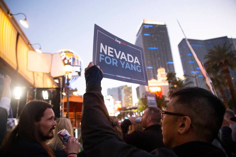 A supporter of former Democratic presidential candidate Andrew Yang holds a sign on the Strip o ...