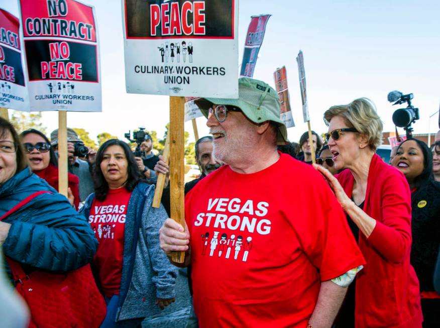 Democratic presidential candidate Sen. Elizabeth Warren, D-Mass., right, talks with workers fro ...