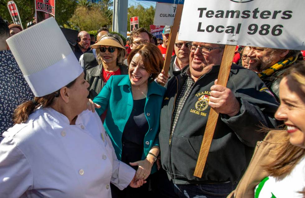 Democratic presidential candidateʓen. Amy Klobuchar, D-Minn., center, greets cook Glenna ...