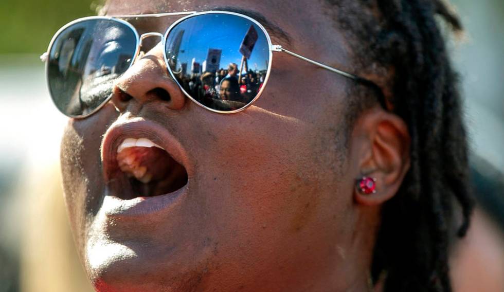 Vernisha Ward with Culinary Union Local 226 yells slogans with other workers from seven Station ...