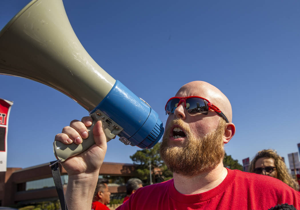 Jacob George with the Culinary Local Union 226 shouts out slogans for workers from seven Statio ...