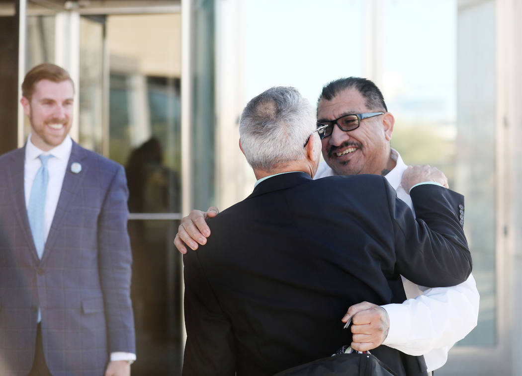 Attorney Shawn Perez, left, hugs defendant Pastor Palafox outside the Lloyd George U.S. Courtho ...