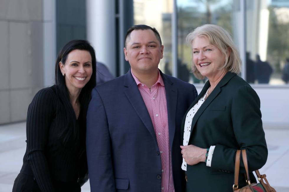 Attorneys Ivette Amelburu Maningo, left, and Kathleen Bliss stand with Diego Garcia, one of eig ...