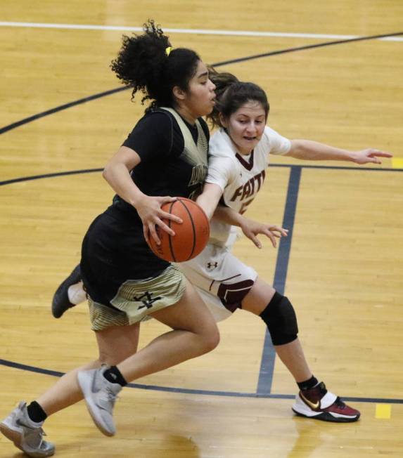 Spring Valley's Riahana Davis, left, drives past Faith Lutheran's Vegas Camacho during the four ...