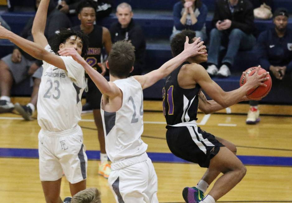 Durango High's Anthony Hunter (21) fouled by Faith Lutheran's Coleman Lemke (24) as he goes for ...