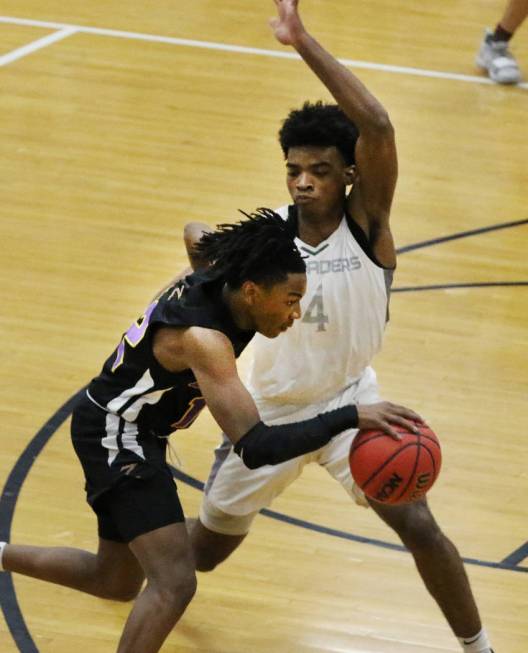 Faith Lutheran's Azavier Johnson (4) defends Durango High's Sebastian Mack (12) during the four ...