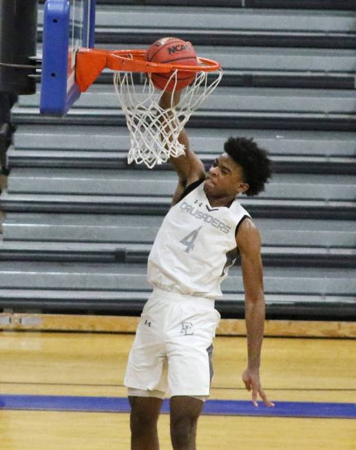 Faith Lutheran's Azavier Johnson (4) dunks against Durango High during the third quarter of the ...