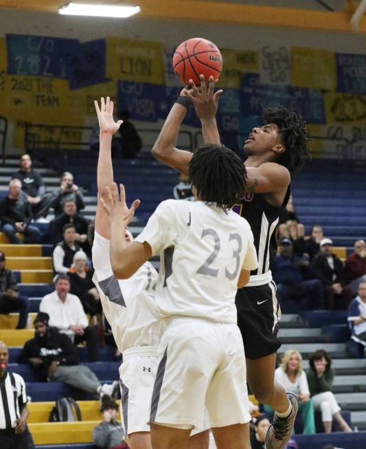 Faith Lutheran's defenders, including Jackson Williams (23), defend Durango High's Kendrick Gil ...