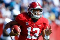 Alabama quarterback Tua Tagovailoa (13) carries the ball during the first half of an NCAA colle ...