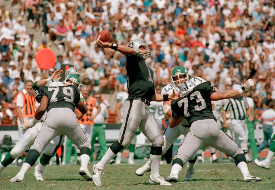 Jim Plunkett, Los Angeles Raiders quarterback winds up to let loose pass to wide receiver Dokie ...