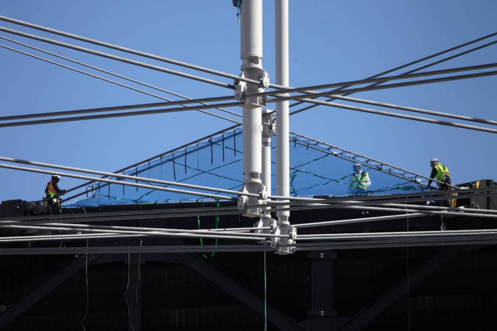 Netting is installed on top of the steel cable net system at the Raiders Allegiant Stadium in L ...