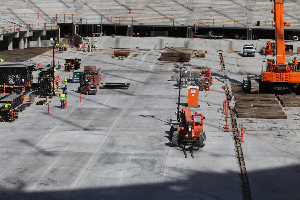 Construction crews on the field level of the the Raiders Allegiant Stadium in Las Vegas, Tuesda ...