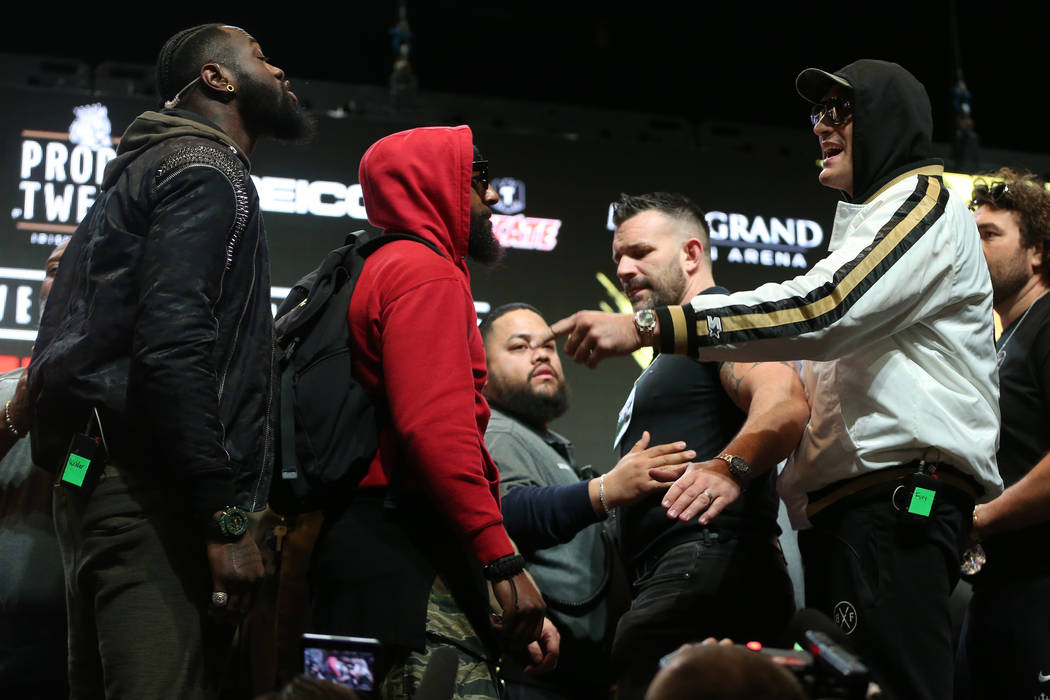 Tyson Fury, right, gestures at Deontay Wilder during a press conference at the MGM Grand Garden ...