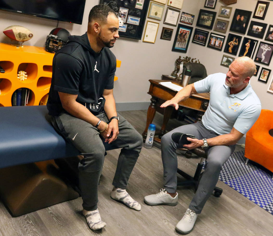 Sports Injury Specialist and Performance Coach Tobe Hanson, right, works with Stanford Universi ...