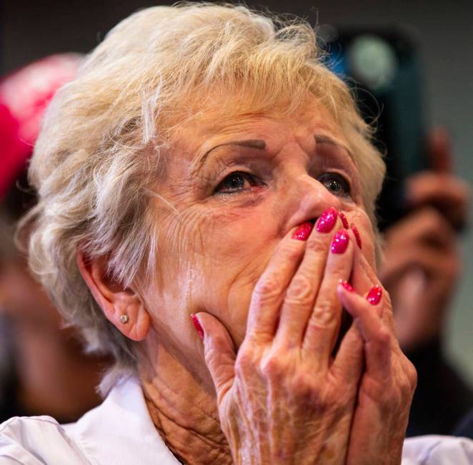 A supporter of President Donald Trump, not pictured, tears up while listening to him speak duri ...