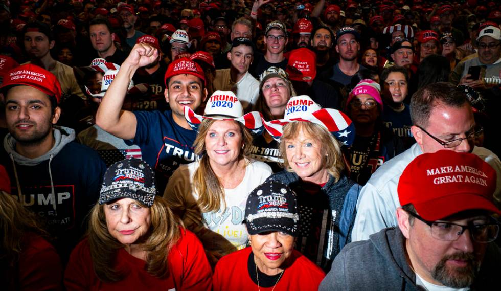 Supporters of President Donald Trump, not pictured, listen as Vice President Mike Pence speaks ...