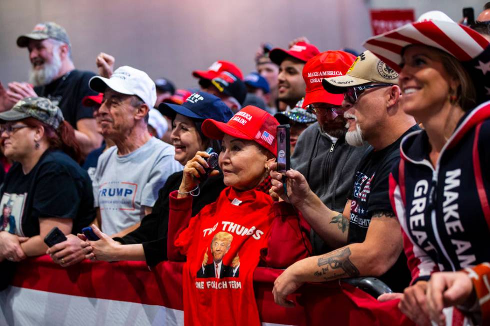 Supporters of President Donald Trump, not pictured, listen as Vice President Mike Pence speaks ...
