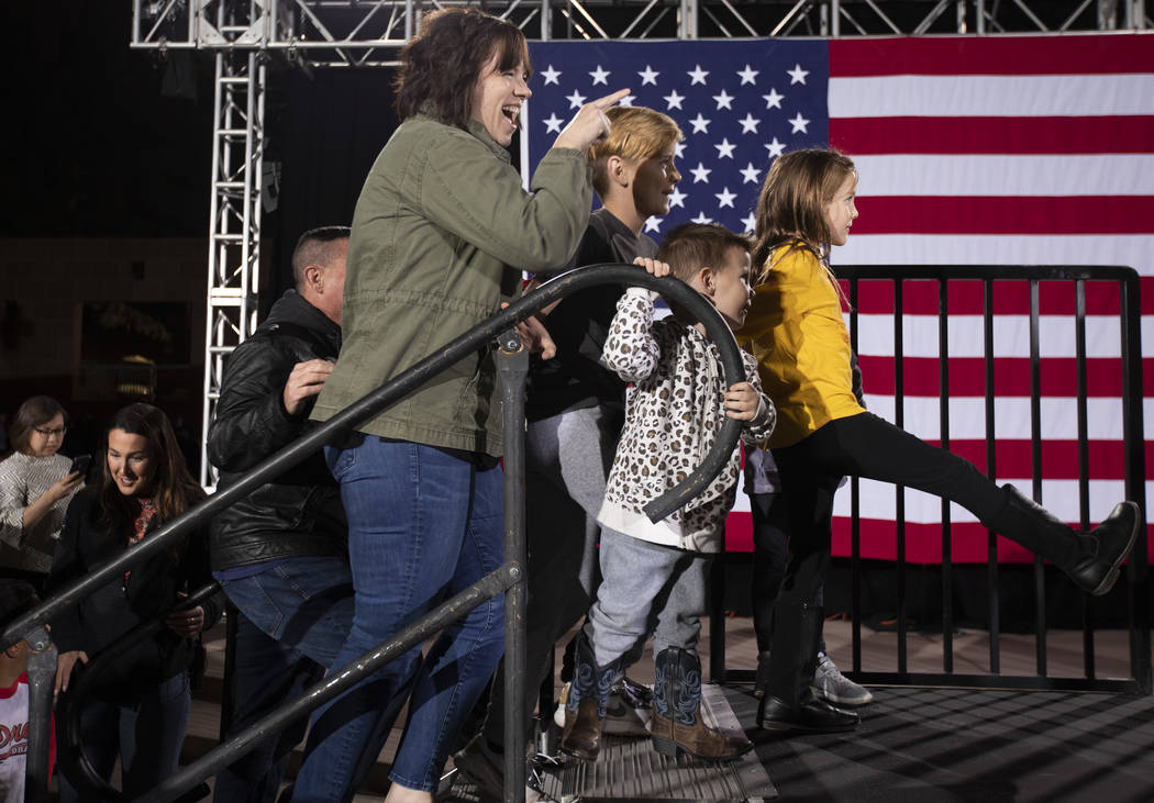 Kim Arkerson points at Sen. Elizabeth Warren, D-Mass., as she, her husband and her six children ...