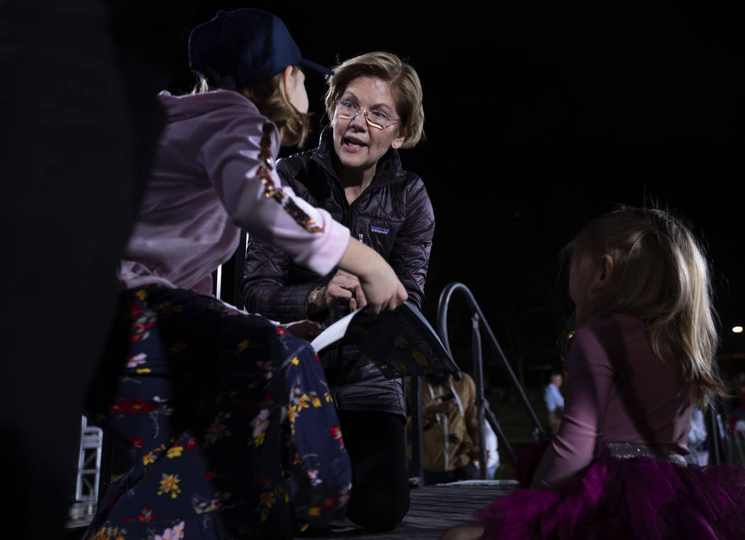 Sen. Elizabeth Warren, D-Mass., signs a presidential book of two young girls after the "Ge ...