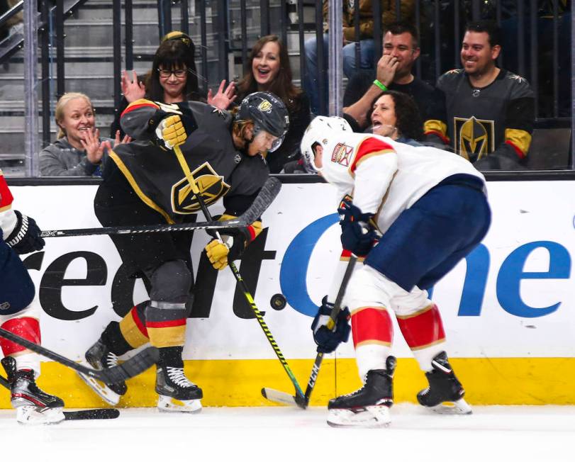 Golden Knights' William Karlsson (71) battles for the puck against Florida Panthers' Josh Brown ...