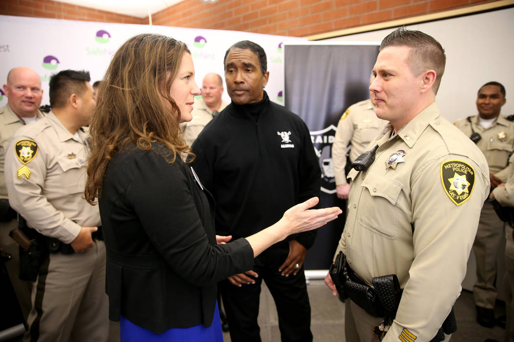 SafeNest CEO Liz Ortenburger visits with Las Vegas police Lt. Timothy Hatchett and Raiders alum ...