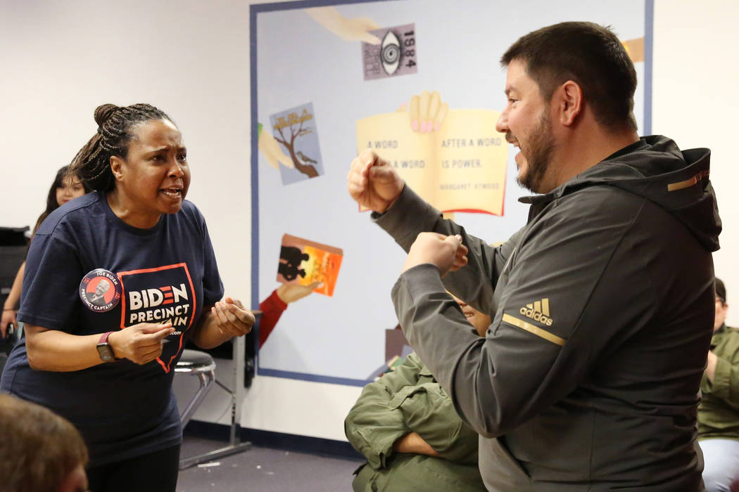 Beverly Jackson, left, Joe Biden supporter, and Michael Alires, undecided voter, debate before ...