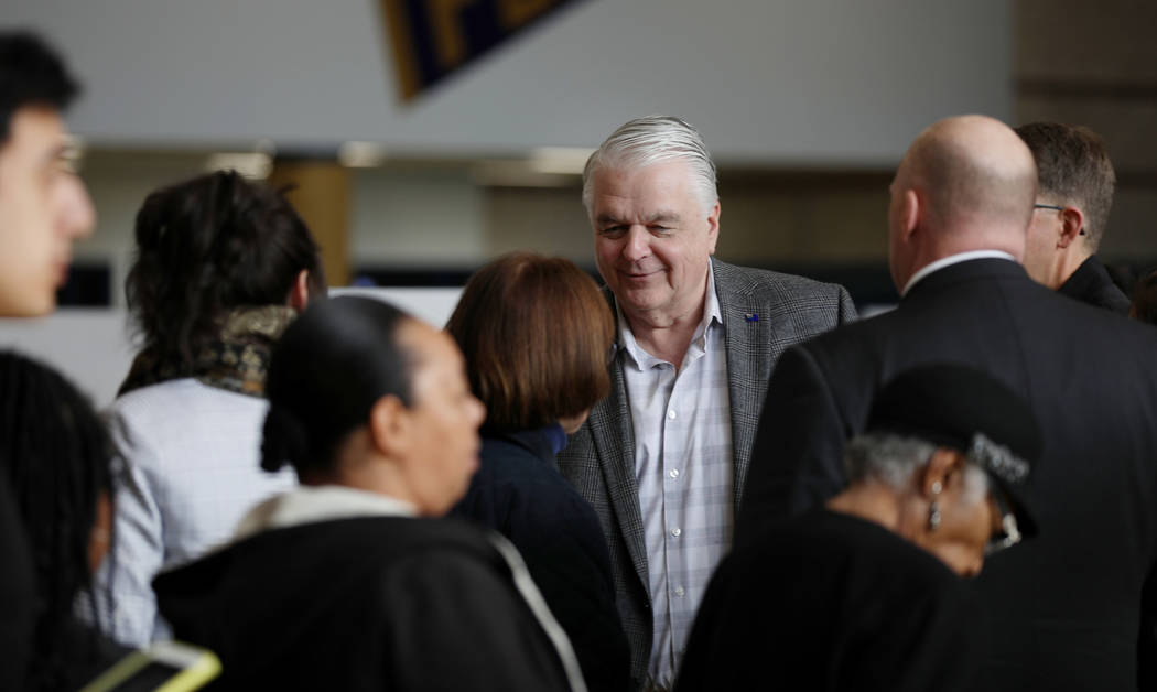 Nevada Gov. Steve Sisolak greets caucus participants at Cheyenne High School in North Las Vegas ...