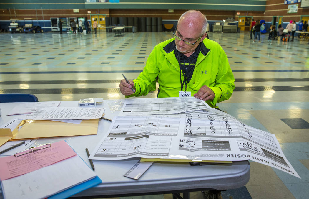 Precinct 3706 captain Jordan Nacov records the final numbers as caucus day voting for Democrati ...