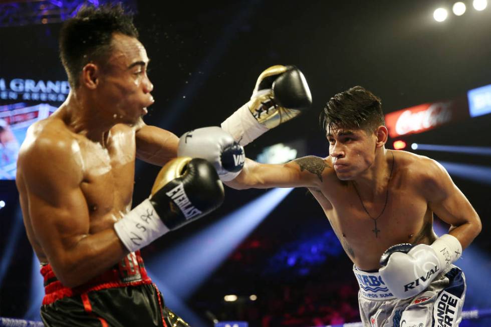 Emanuel Navarrete, right, connects a punch against Jeo Santisima in round 3 of the super bantam ...