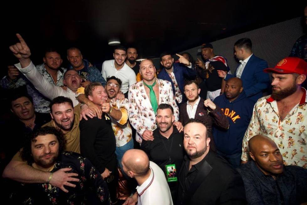 Tyson Fur (center, in suit) and his entourage are shown celebrating his seventh-round TKO victo ...