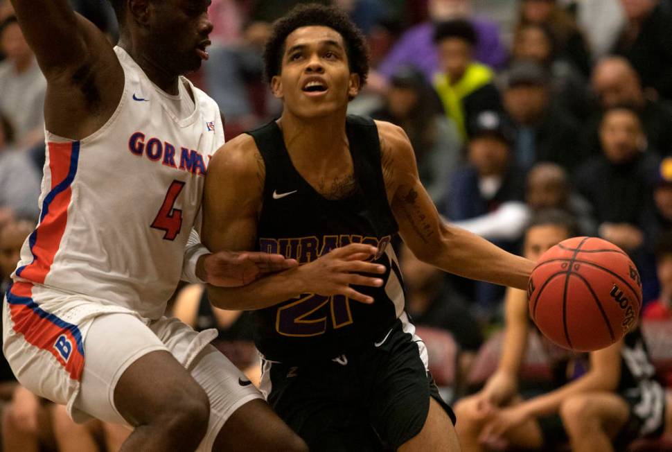 Bishop Gorman's Jonathan Braggs (4) defends against Durango's Anthony Hunter (21) at Desert Oas ...