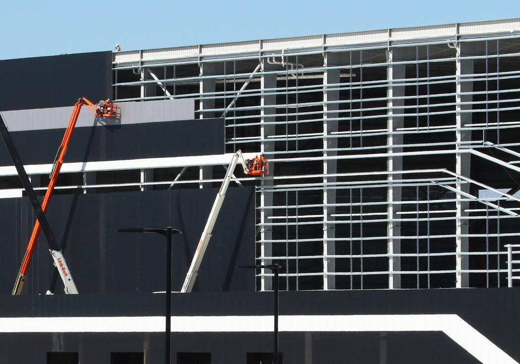 Workers are seen at the Raiders' under-construction practice facility in Henderson on Monday, F ...