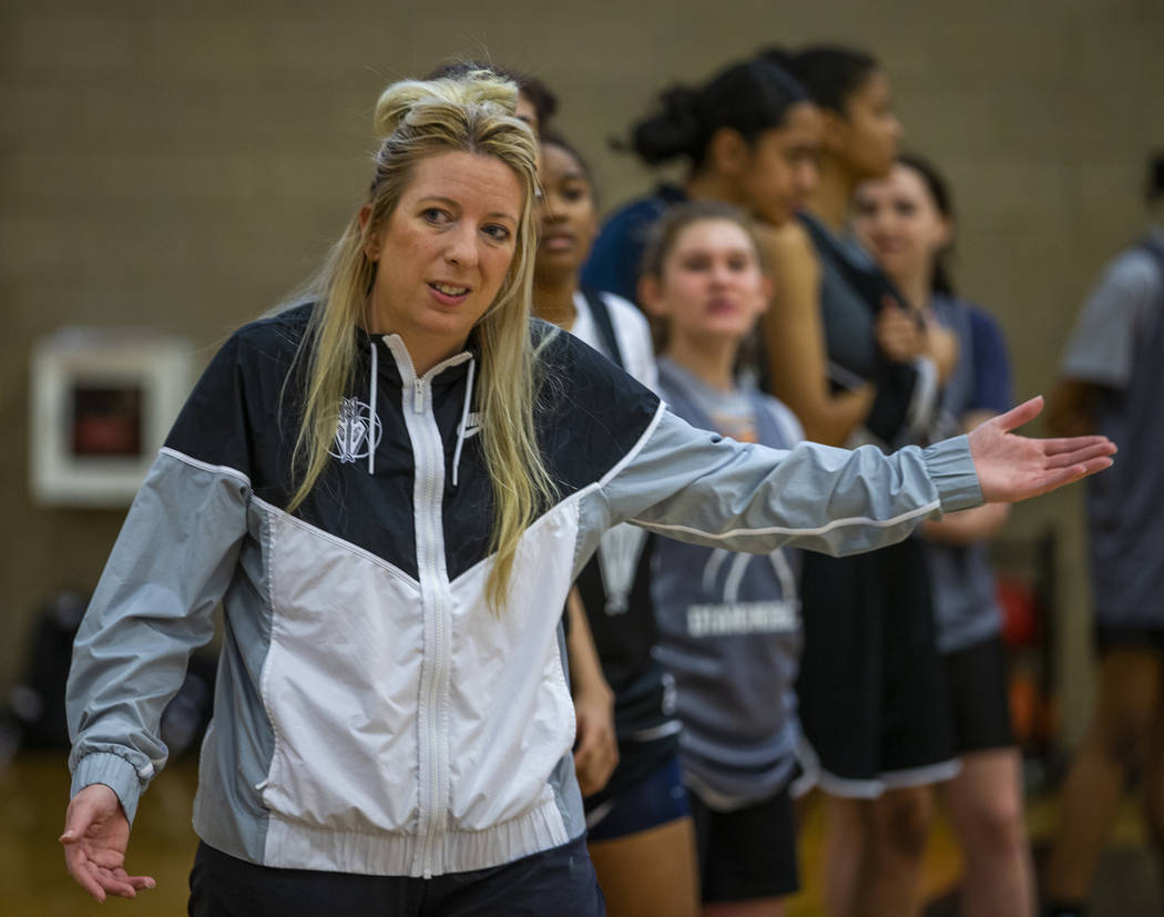 Head coach Laurie Evans, center, instructs some of her players during a Desert Oasis girl's bas ...