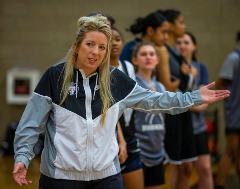 Head coach Laurie Evans, center, instructs some of her players during a Desert Oasis girl's bas ...