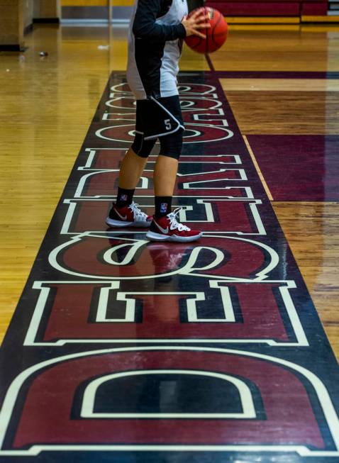 Player Olivia Bigger readies to send a pass in to a teammate during a Desert Oasis girl's baske ...