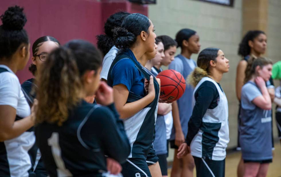 Desert Oasis girl's basketball team players stand on the base line and listen to instructions b ...