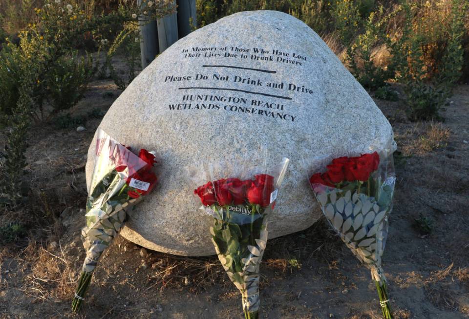 Three bouquets of roses, one for each of the teens killed in a fiery crash in 2018 in Huntingto ...