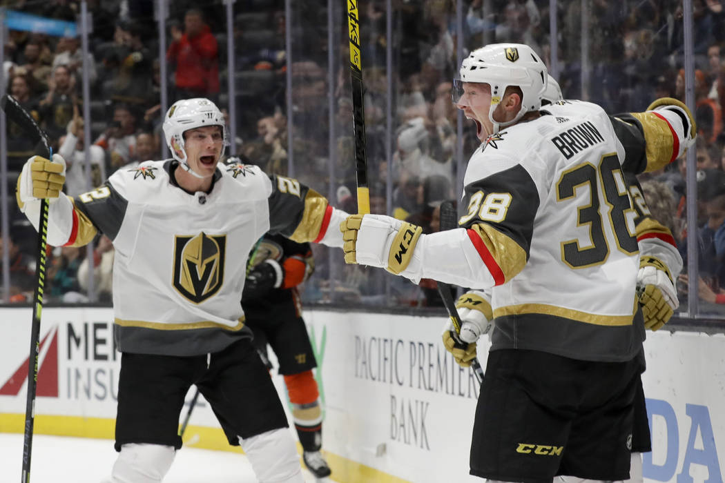 Vegas Golden Knights center Patrick Brown, right, celebrates with defenseman Nick Holden, left, ...